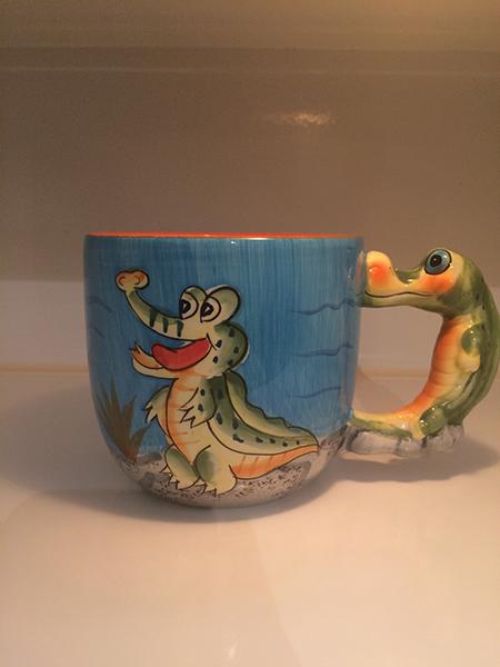 Not sure which is more dangerous – the alligator or the contents of the mug? 