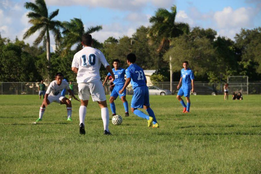 Senior forward Mathew Posada attempts to win back the possession after the South Dade defender stifles a Palmetto scoring opportunity.