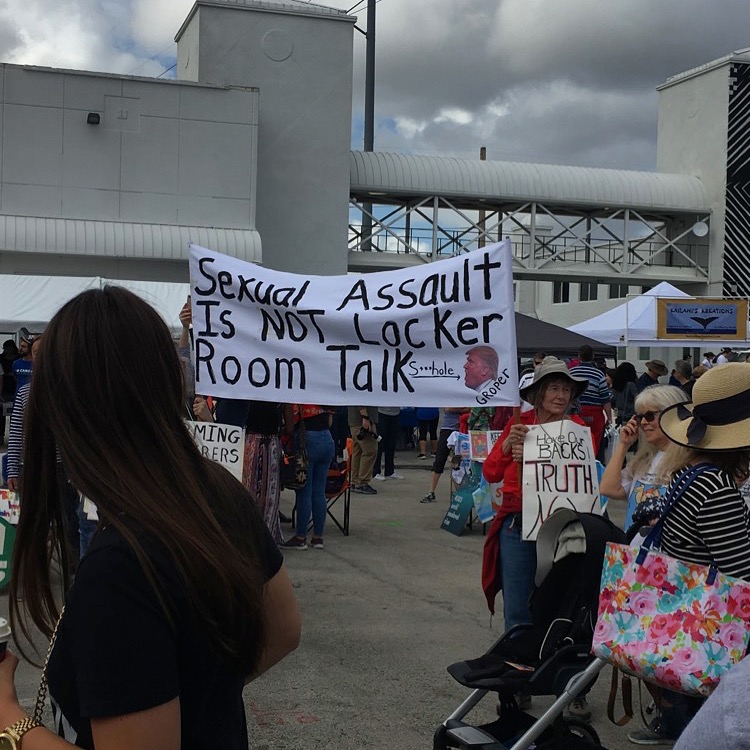 Demonstrators hold up an anti-Trump banner at the second annual Womens March in Miami, FL.
