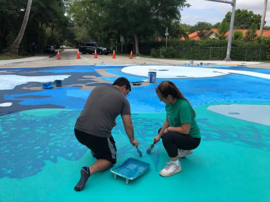 Students from Westminster paint the number nine of the corner of 67th avenue and 112th street.