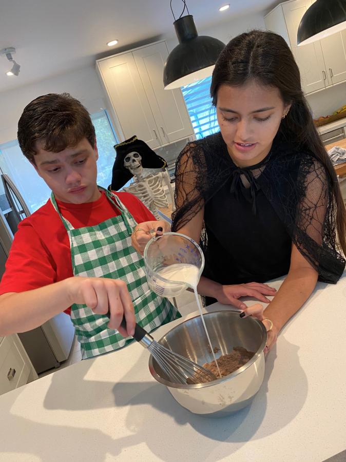 Sofia Palacios and her brother, Gabriel, demonstrate how to bake a Halloween treat for their class (photo courtesy of Palacios).