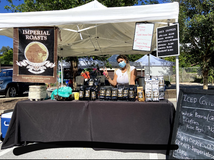 Imperial Roast employee Queenray Sybil poses in front of her stand.