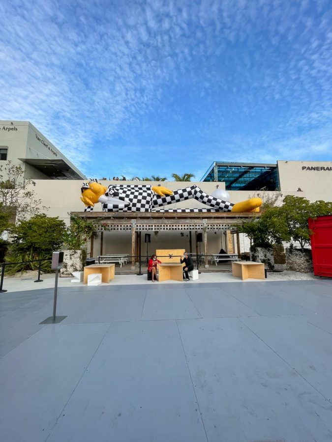One of Louis Vuittons larger-than-life balloon figures laying on top of a resting area.