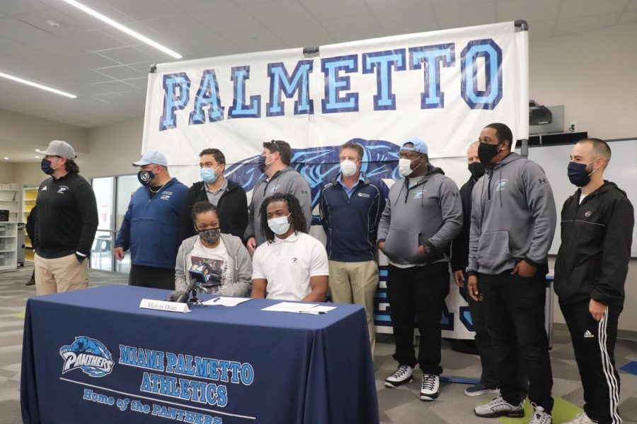 Dean poses with the football coaching staff after announcing his decision. 