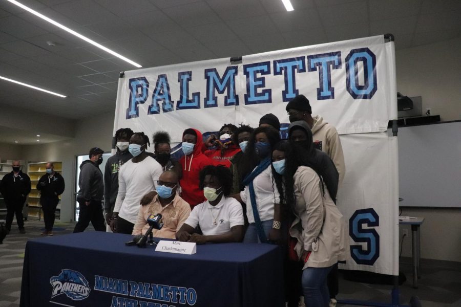 Charlemagne poses with his family after announcing his commitment. 