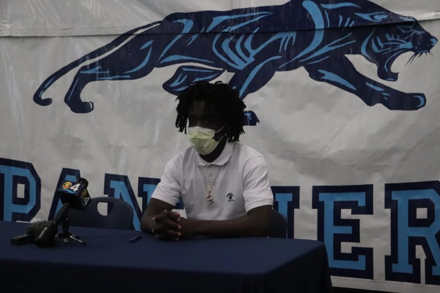 Charlemagne sits and reflects after officially signing to Glenville State. 