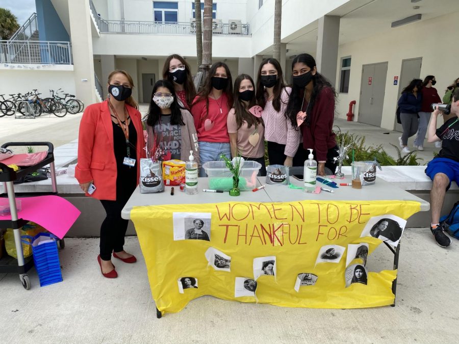 Women’s Union celebrating Woman’s Day by handing out candy and heart shaped necklaces all throughout Miami Palmetto Senior High School.