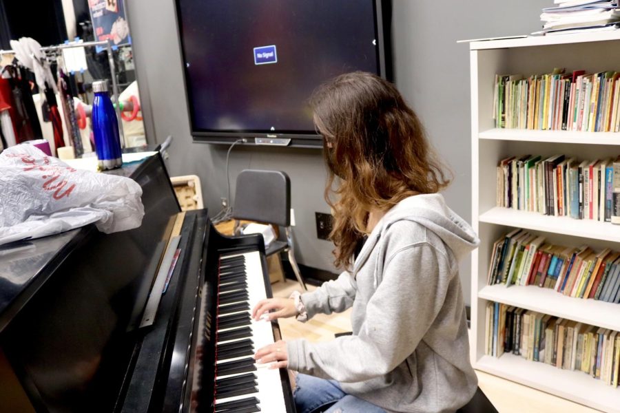 Senior Copy Editor Katriona Page demonstrates playing the piano.
