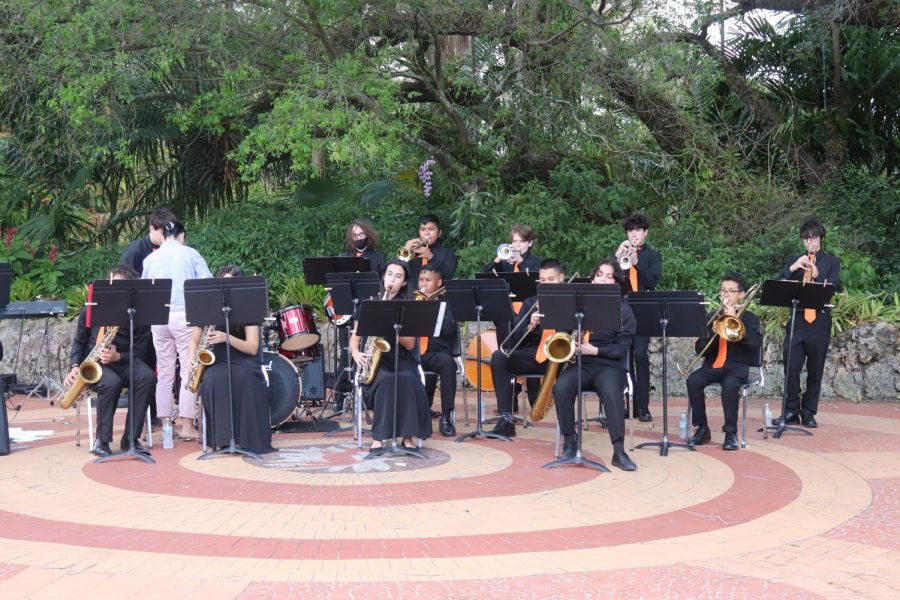 Orchestra group performing for crowd in the Pinecrest Gardens patio.