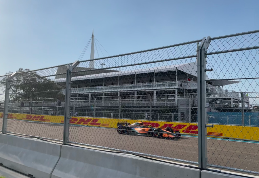 Daniel Ricciardo, driver for McLaren's F1 team, speeds toward the East campus during a practice round.