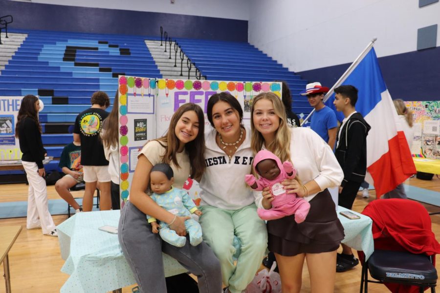 Palmetto senior, Bethany Defarrari and others holding mock babies for FFEA club.
